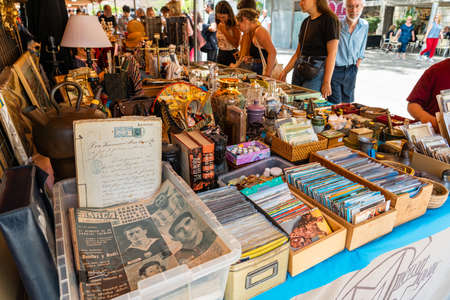 BARCELONA, SPAIN - JUNE 10, 2019: Antique objects, coins, jewels, tableware and other utensils at a flea marketのeditorial素材
