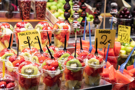 BARCELONA, SPAIN - JUNE 14, 2019: People Shopping For Healthy Fresh Fruits And Vegetables For Sale In Fruit Marketのeditorial素材