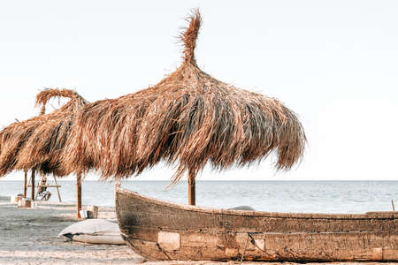 Umbrellas, Boat and Sandy Beach Sea Landscapeの写真素材