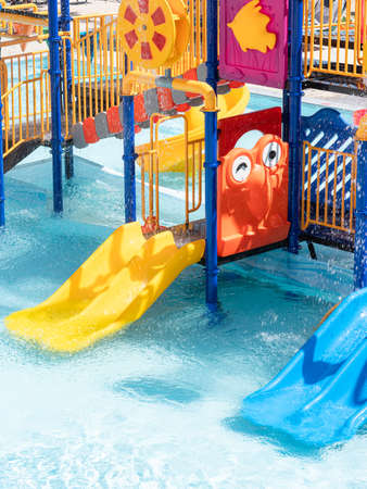 Children Playground with Colorful Yellow And Blue Plastic Slider in Swimming Pool Aquaparkの写真素材