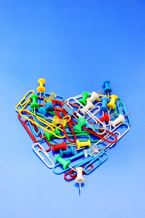 a colored heart  of clips and tacks of office