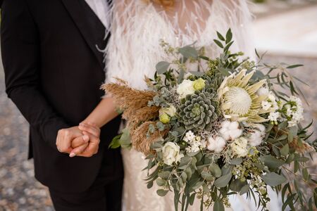 Bride and groom holding handsの写真素材