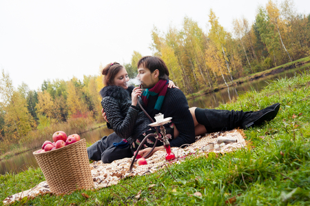 relationship between man and a woman at a picnic with a hookahの写真素材