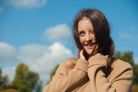 happy woman laughing on the background of blue skyの写真素材