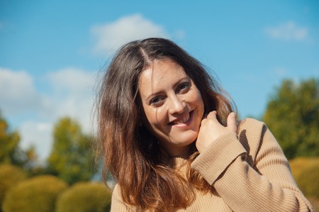 happy woman laughing on the background of blue skyの写真素材