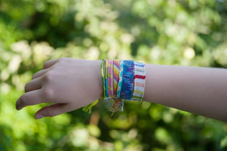 many braided bracelets on hand in the summerの写真素材