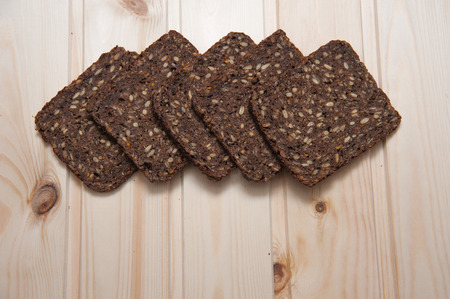 rye bread with sunflower seeds on a wooden background