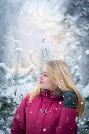 girl with long brown hair in a winter forestの写真素材