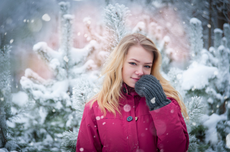 girl with long brown hair in a winter forestの写真素材