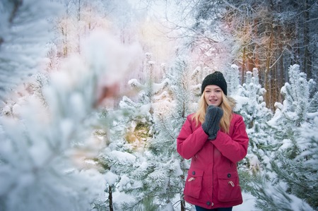 girl in hat and mittens in winter forest oneの写真素材