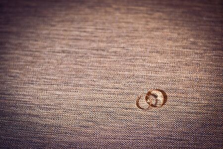 Two wedding gold rings on a gray backgroundの写真素材