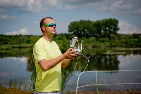 young man controls the drone by remote