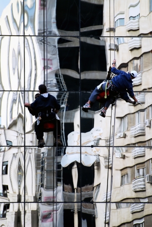 Window cleaners on skyscraperの写真素材