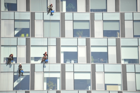 Window cleaners on skyscraperの写真素材