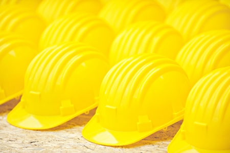 Yellow protection helmets in a rowの写真素材