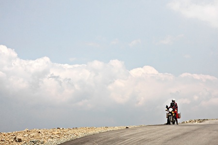 TRANSYLVANIA/ROMANIA - JUNE 18: Two-up on a motorcycle riding the Transalpina road located in the Parang Mountain range, Transylvanian Alps Mountains on June 18, 2011 in Romania. Transalpina highest point is in Urdele Pass, at 2,145 meters above sea levelのeditorial素材