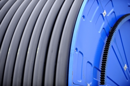 Big blue reel with industrial irrigation hoseの写真素材