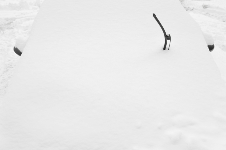 Snow covered car after heavy snowfallの写真素材