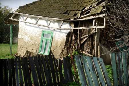 An old traditional adobe house damaged in time by weatherの写真素材