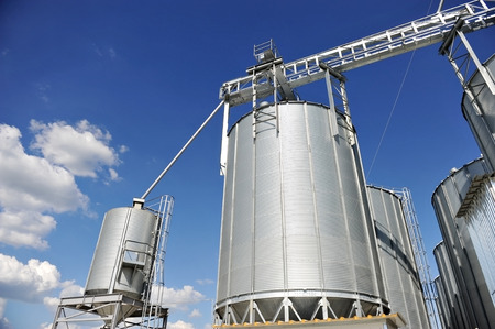 Industrial grain silo with blue sky on the backgroundの写真素材