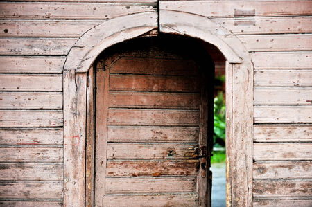 Architecture detail with a very old wooden house front doorの写真素材