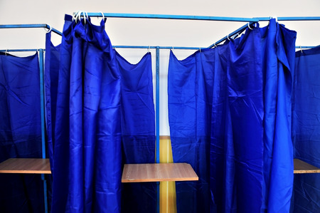 Voting booths with blue drawn curtains and no people insideの写真素材