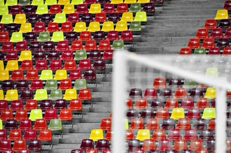 Detail with empty colored sports arena tribunes on a football stadiumの写真素材