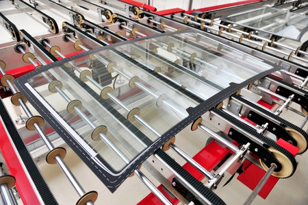 Industry detail with a rear car glass on the production line in a glass factoryの写真素材