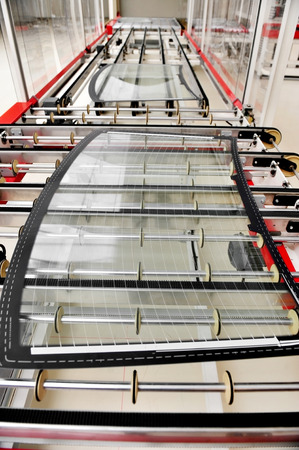 Industry detail with a rear car glass on the production line in a glass factoryの写真素材