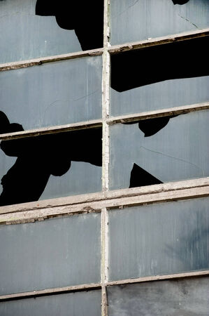 Broken windows from an old industrial buildingの写真素材