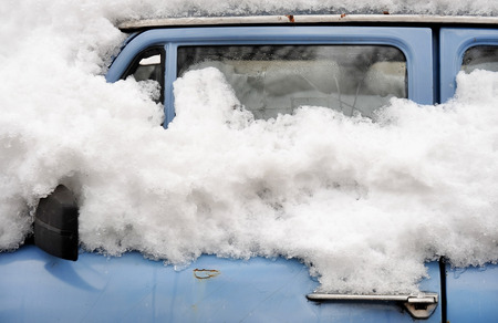 Detail shot with an abandoned old car in winter timeの写真素材