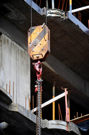 Industrial crane hook on a construction siteの写真素材