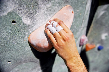 Detail with climber injured hand on artificial indoor climbing wallの写真素材
