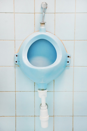 Detail with one blue urinal in a public men's toiletの写真素材