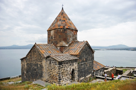 SEVAN, ARMENIA - JULY 5, 2014: Tourists visiting the Sevanavank monastery situated on the shore of Sevan Lake, one of the largest freshwater high altitude lakes in the world.のeditorial素材