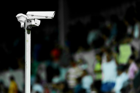 Two surveillance cameras pointed towards a tribune on a sports arenaの写真素材