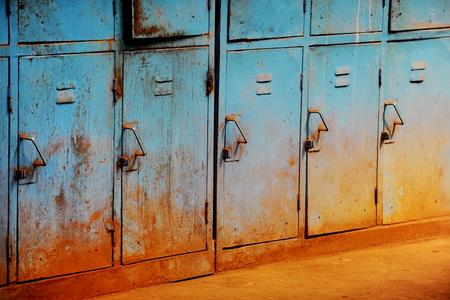 Old and rusty blue lockers abandoned inside industrial buildingの写真素材