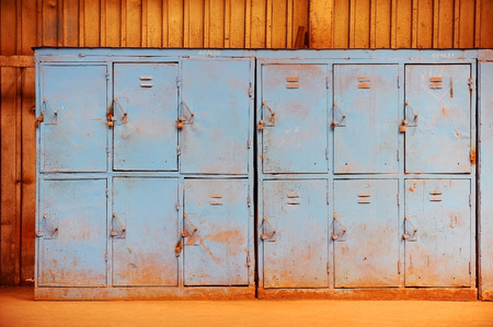 Old and rusty blue lockers abandoned inside industrial buildingの写真素材