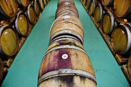 Industry detail with several wooden wine barrels in a wine cellarの写真素材