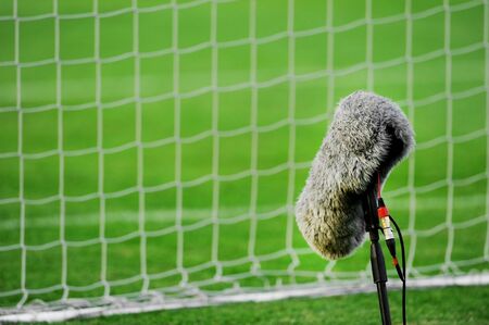 Professional sport microphone on a soccer field behind the netの写真素材
