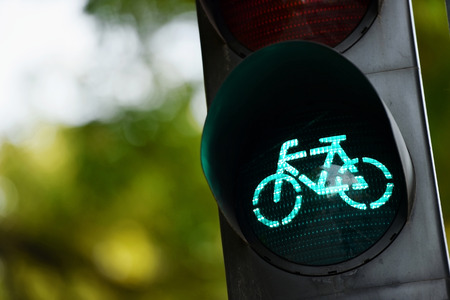 Detail shot with a bicycle traffic light switched to green colourの写真素材