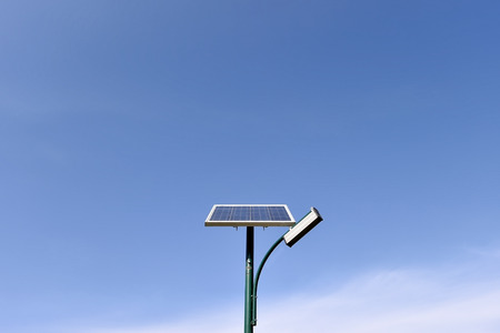 Solar street lamp in a park isolated on a clear blue skyの写真素材