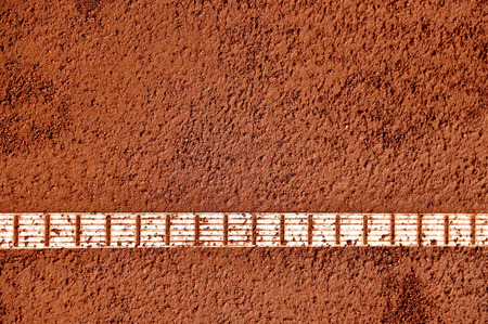 Detail with sideline and moisture on a tennis clay court