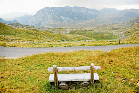 Empty wooden bench on Sedlo Pass in Durmitor National Park in Montenegroの写真素材