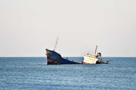 Industrial shipwreck abandoned into sea near the coastline