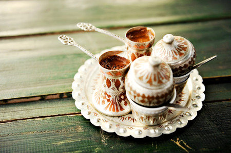 Two cups of bosnian traditional coffee on a wooden tableの写真素材