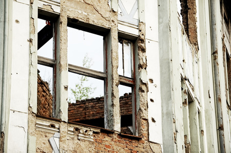 Traces of bullets on a building facade destroyed by war