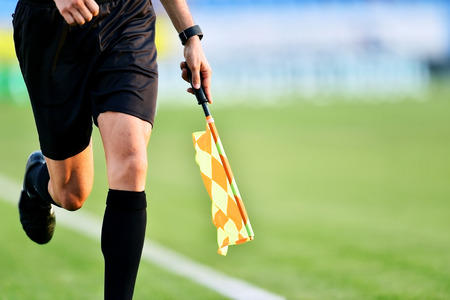 Assistant referee moving along the sideline during a soccer matchの写真素材