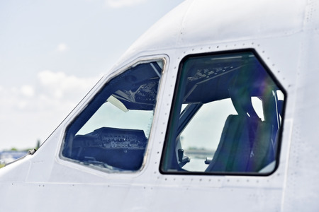 Detail shot with pilot cockpit seen from outside airplaneの写真素材