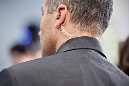 Detail with a bodyguard wearing in ear headset
